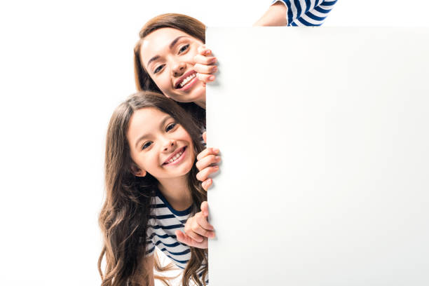 istock Daughter and mother holding empty board 898315088