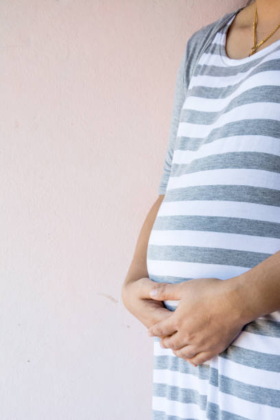 istock mother pregnant take a shot close up view 898319520