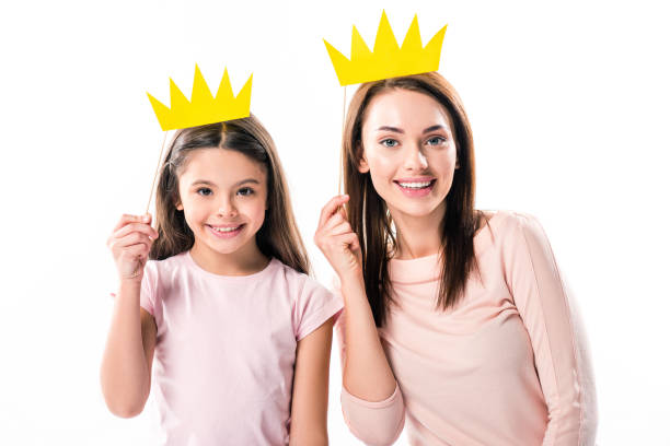 istock Mother and daughter with paper crowns on stick 898321986