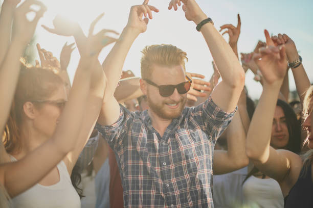 istock Crowd of people dancing at festival 898325432