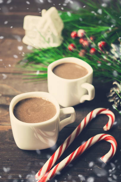 istock Christmas home concept with two hot drinks, lollipops and toy house 898330742