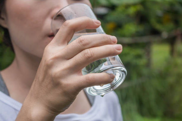 istock Midsection Of Woman Drinking Water 898330896