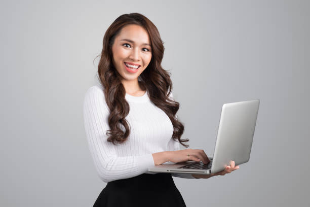 istock Confident young asian woman holding laptop 898333994