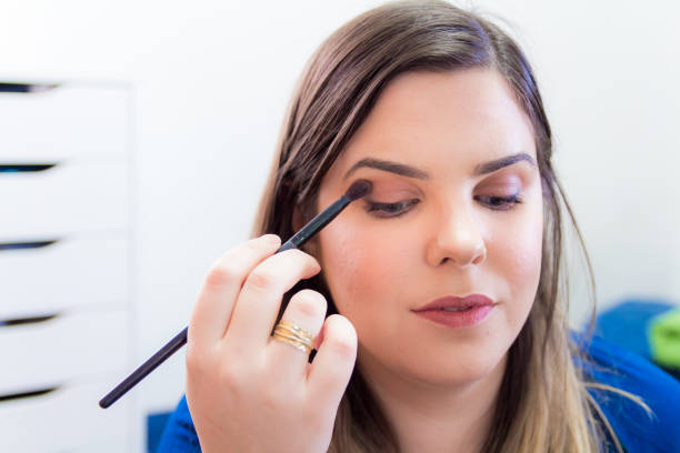 istock Woman applying makeup in her bedroom 898335548
