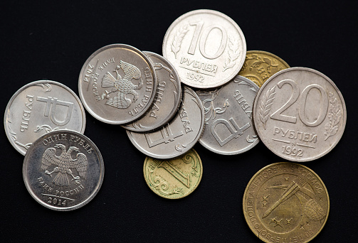Old coins of the USSR on a black background .