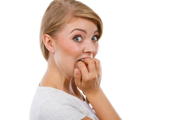 istock Scared, stressed woman biting her nails 898338374