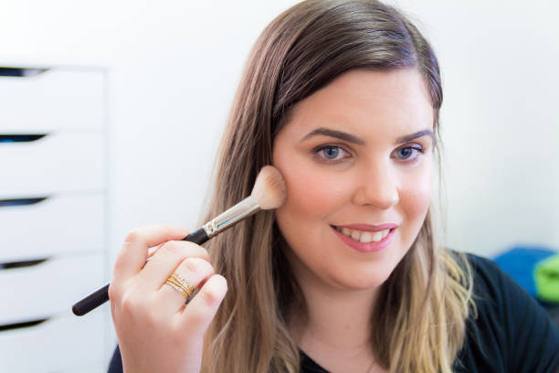 istock Woman applying makeup in her bedroom 898338706