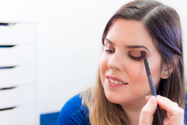 istock Woman applying makeup in her bedroom 898339208