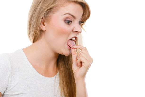 istock Woman having something disgusting on tongue 898340258