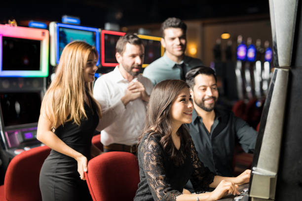 istock Group of people playing in slot machine 898340984
