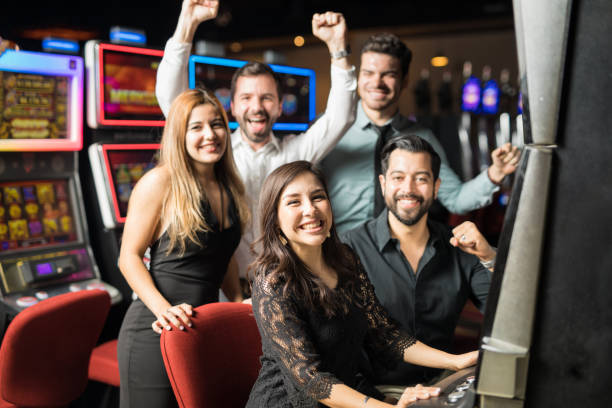 istock Friends playing slots in a casino 898341236