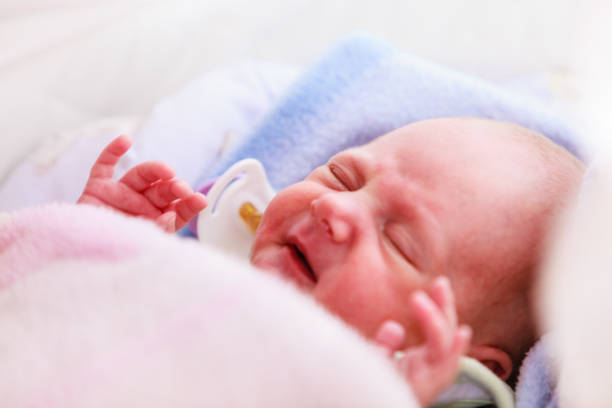 istock Little newborn baby sleeping calmly in blanket 898341864