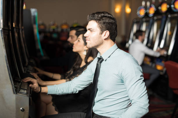 istock Man playing in a slot machine 898342836