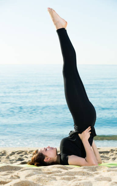 istock Woman in black T-shirt is stretching 898343534