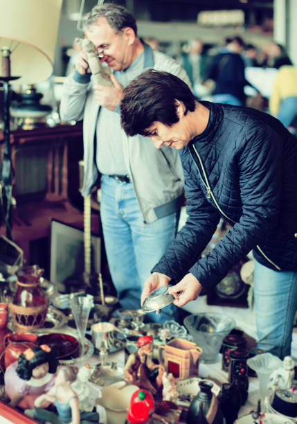 istock concentrated elderly woman choosing interesting souvenirs at flea market 898344276