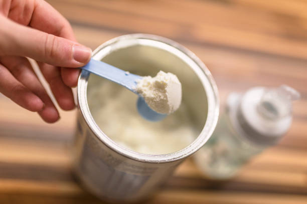istock Powdered milk with spoon for baby. 898344384
