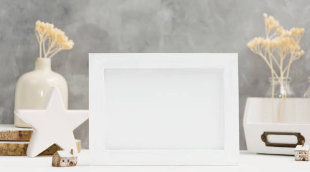istock Bright Photo frame close up mock up with plants in vase, ceramic decor on shelf against grey wall. Scandinavian style 898345778