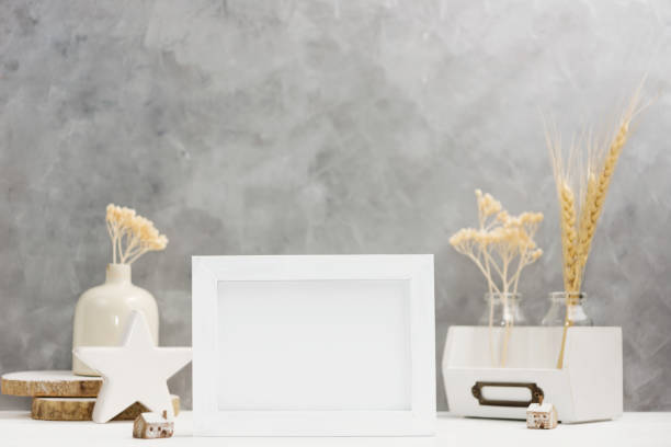 istock Bright Photo frame mock up with plants in vase, ceramic decor on shelf against grey wall. Scandinavian style 898345786