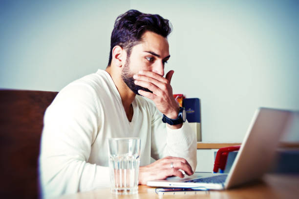istock Young man on laptop have trouble 898345978