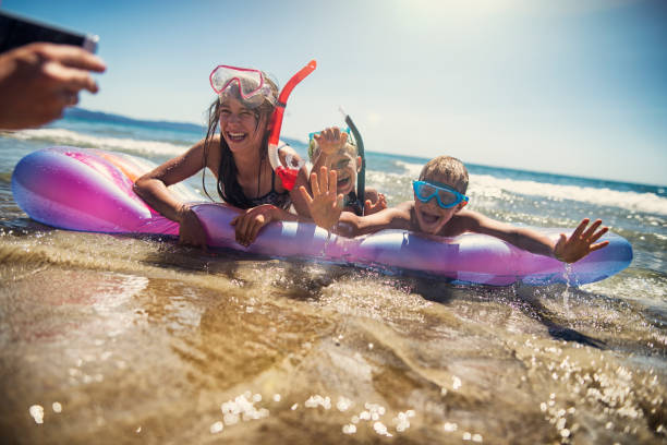 istock Kids playing on beautiful sea beach 898347018