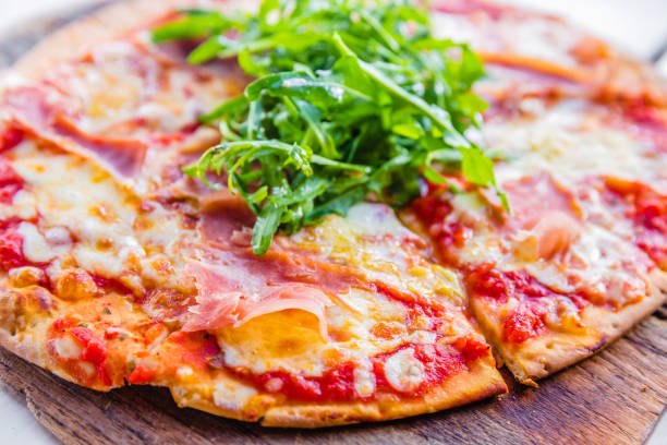 istock Pizza with prosciutto,cheese and rocket salad 898347494