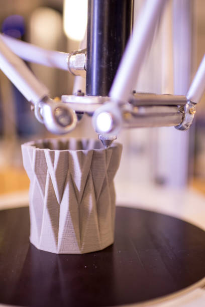 istock 3d printer in the process of making a geometric vase 898348352
