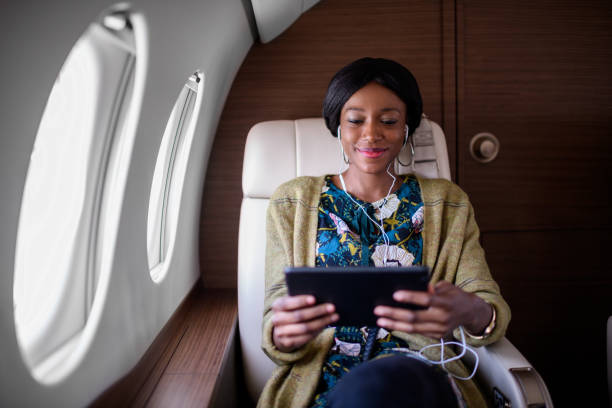 istock Woman in private jet airplane 898349600