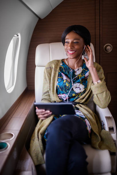 istock Woman in private jet airplane 898349682