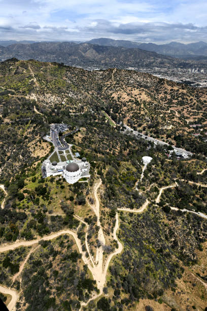 Griffith Park Observatory Helicopter point of view of Griffith Park Observatory in Los Angeles, CA with surrounding area. griffith park observatory stock pictures, royalty-free photos & images