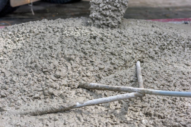 istock Concrete pouring during commercial concreting floors and worker is working 898351956