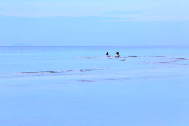 istock Happy two girls enjoying on the beach 898352200