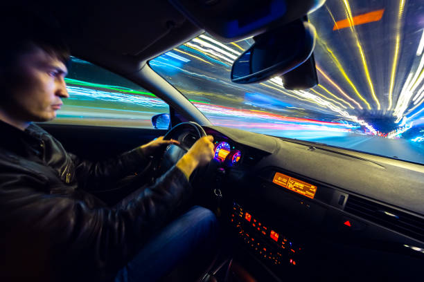 istock Driver in car moves at fast speed at night. 898352494