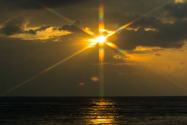 istock COLORFUL FLARE WITH SUNLIGHT REFLECTING ABOVE OCEAN BEFORE DUSK TIME 898352576