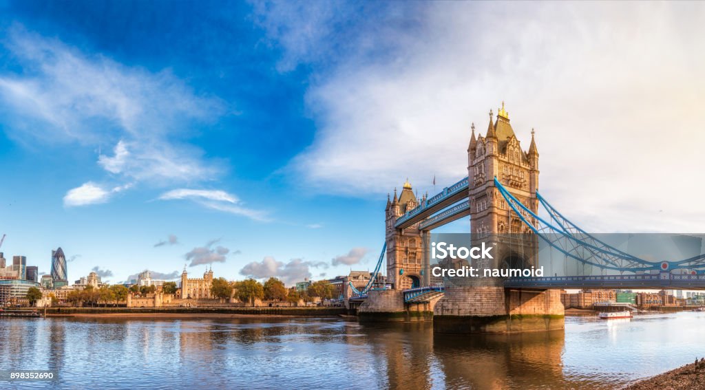 London cityscape panorama with River Thames Tower Bridge and Tower of London in the morning light Panoramic London skyline with iconic symbol, the Tower Bridge and Her Majesty's Royal Palace and Fortress, known as the Tower of London as viewed from South Bank of the River Thames in the morning light Tower Bridge Stock Photo