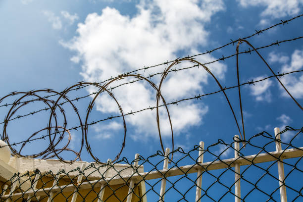 istock Coils of Razor Wire on Fence 898352838