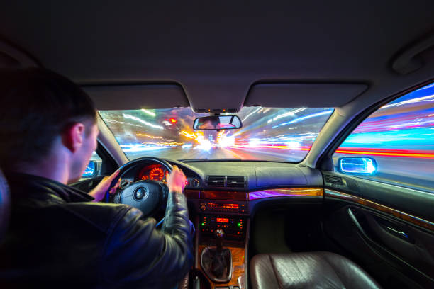 istock Driver in car moves at fast speed at night. 898354686