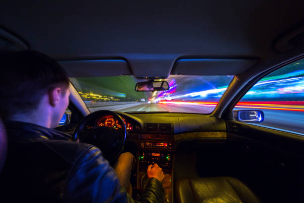 istock Driver in car moves at fast speed at night. 898355748