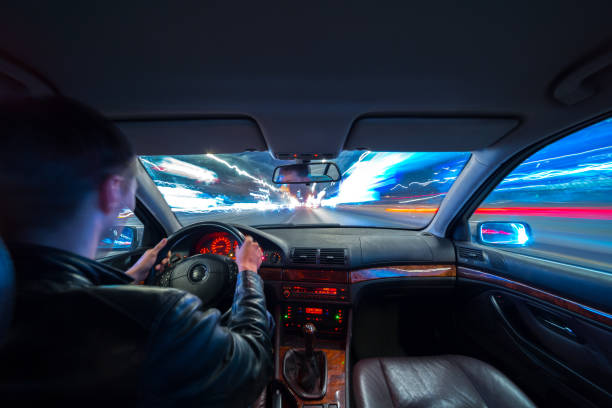 istock Driver in car moves at fast speed at night. 898356778