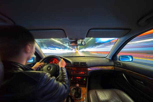 istock Driver in car moves at fast speed at night. 898357356