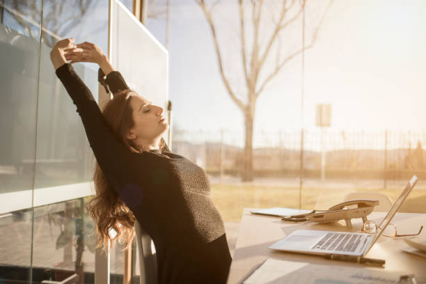 istock Woman stretching in the office 898357568