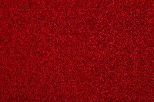 close up view of red leather fabric texture