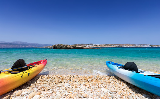Canoes lying on a pebble beach in the Cyclades of Greece, Aegean Sea