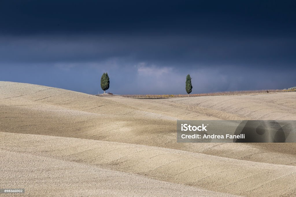 Storm in val d'orcia Typical tuscany landscape before a massive storm Beige Stock Photo