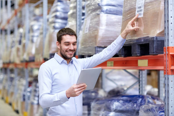 istock happy businessman with tablet pc at warehouse 898365036