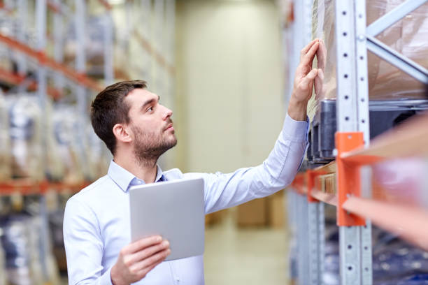 istock businessman with tablet pc at warehouse 898365556