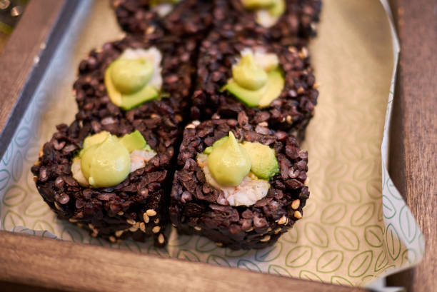 Black rice rolls with avocado and shrimps
