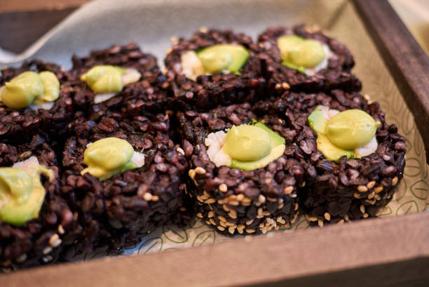 istock Black rice rolls with avocado and shrimps 898366320