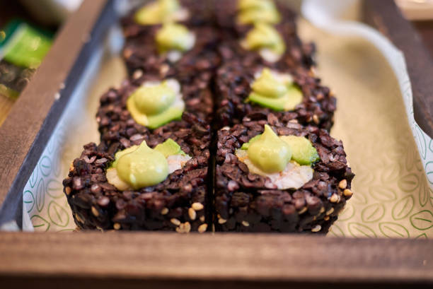 Black rice rolls with avocado and shrimps