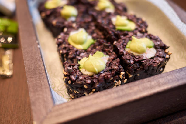 Black rice rolls with avocado and shrimps