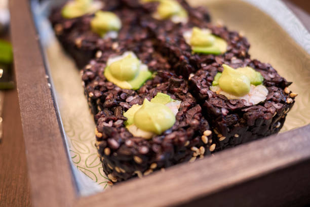 Black rice rolls with avocado and shrimps